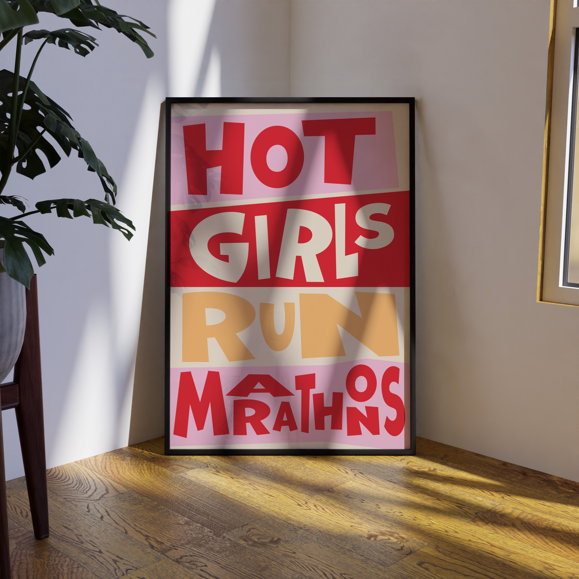 Framed poster with text 'HOT GIRLS RUN MARATHONS' on a wall in a room.