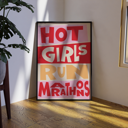 Framed poster with text 'HOT GIRLS RUN MARATHONS' on a wall in a room.